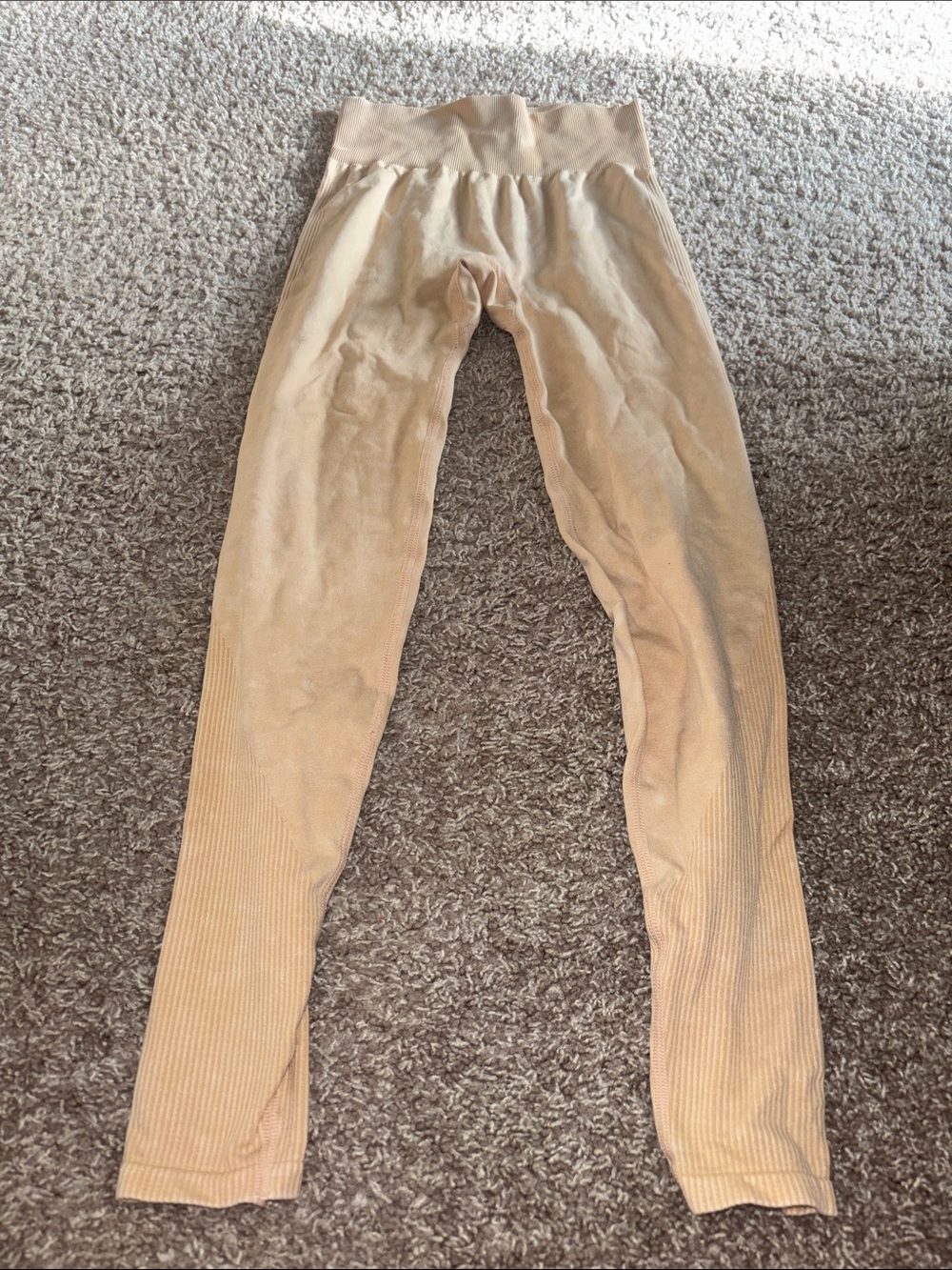 Pink leggings in a peachy/beige color